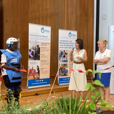 Entminerin Elisabeth Sambou, Außenministerin Annalena Baerbock und Dr. Eva Maria Fischer von HI im Gespräch beim Tag der offenen Tür im Auswärtigen Amt.