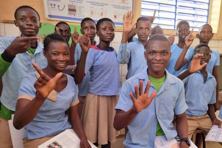 Ein junges Mödchen macht während des Unterrichts mit ihren Füßen Notizen.